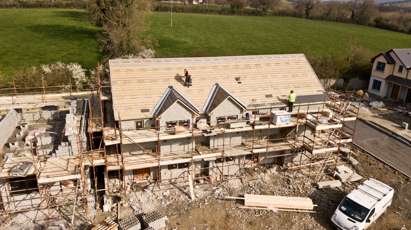 Residential remodel site with scaffolding and construction debris
